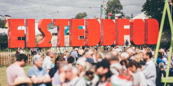 Eisteddfod sign with people in front of it